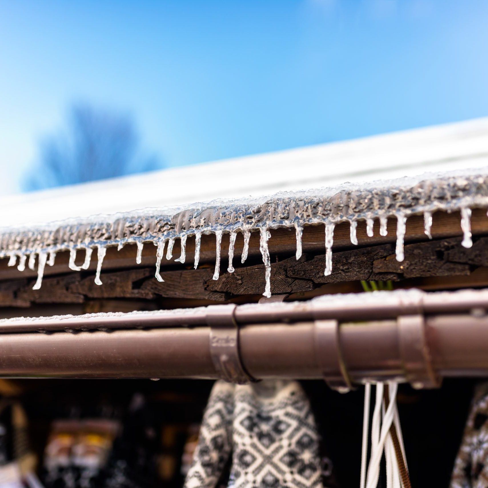 hanging-icicles-from-the-roof-of-a-wooden-building-2021-08-29-12-49-54-utc
